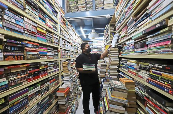 Young bookshop owner Sabri Sabran Naseer Khan seen at his seco<em></em>ndhand bookstore, which he took over from his father, at Chowrasta Market.