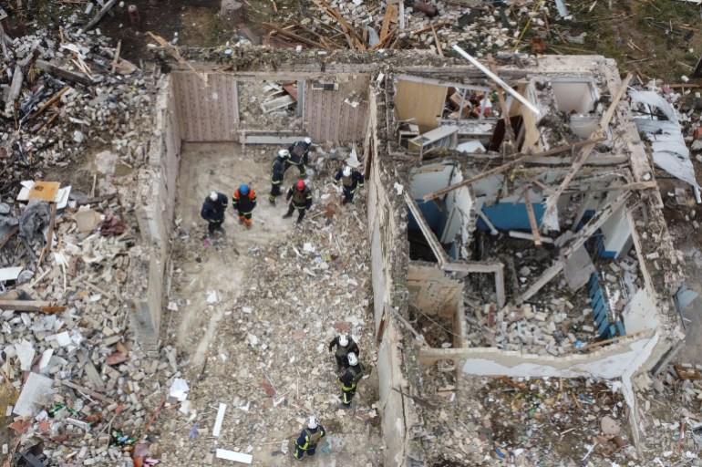 Rescues remove debris at a site of buildings of a local cafe and a grocery store, wher<em></em>e at least 52 people were killed by a Russian missile strik