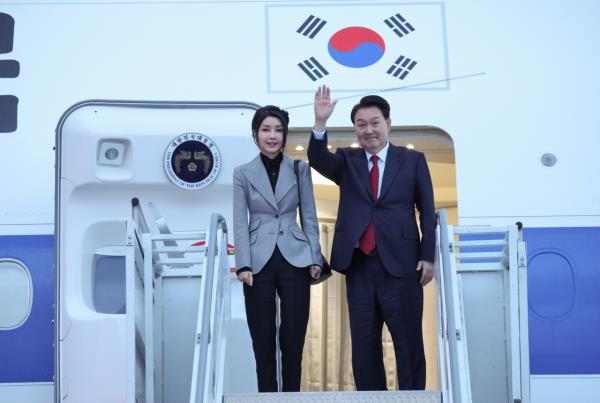 President Yoon Suk Yeol (right) and first lady Kim Keon Hee bid farewell aboard the presidential plane before departing San Francisco Internatio<em></em>nal Airport in San Francisco on Nov. 17. (Yonhap)